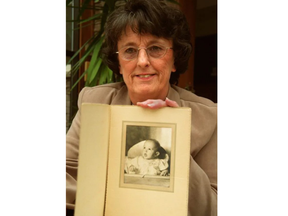 Kathie Roedding with photo of herself when she was baby. Roedding was born in an iron lung as her mother battled polio.