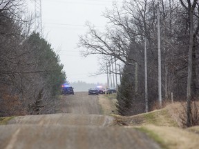 Several police vehicles line on Gentleman Road near Melbourne Road in Muncey, southwest of London, on Thursday April 1, 2021. The road was closed to traffic. Derek Ruttan/The London Free Press/Postmedia Network