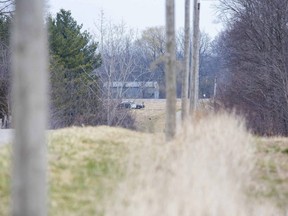 An OPP cruiser sits in the driveway of a home on Duff Line south of Melbourne on Monday April 5, 2021. Duff Line is closed between Cowal  and Iona roads as police investigate a homicide. (Derek Ruttan/The London Free Press)