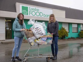 Maddy Bellmore, left, and her mother Jen Bellmore spent part of their Easter Monday sorting items donated to the spring food drive at the London Food Bank. Photograph taken Monday April 5, 2021. Derek Ruttan/The London Free Press