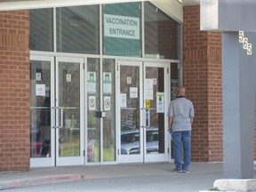 A man waits to enter the COVID-19 vaccination clinic at the Caradoc Community Centre in Mt. Brydges. (Derek Ruttan/The London Free Press)