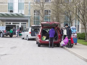 Western University students pack up their belongings as they move out of Perth Hall residence in London on Sunday April 11, 2021. Western asked students earlier this month to move home following a number of COVID-19 outbreaks at student residences. (Derek Ruttan/The London Free Press)