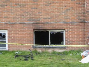A fire-damaged ground-floor window is shown at a King Edward Avenue apartment building in London, hours after a blaze forced out residents. Photo taken Thursday April 22, 2021. (Derek Ruttan/The London Free Press)