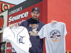 Kevin Dugal of London's Source For Sports displays London Tigers clothing that the store has produced for fans of the long-gone baseball team. (Derek Ruttan/The London Free Press)