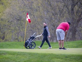 Golfers play a round Monday, April 26, 2021, at The Bridges at Tillsonburg golf course in defiance of the provincial stay-at-home order. No charges or fines have been levied against owners or golfers as of Monday afternoon. (The London Free Press)