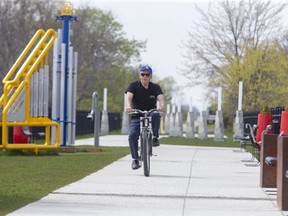 Louis Bertasson rides his bicycle across the Elevated Park in  St. Thomas, on Wednesday April 28. "I love riding on this," he said. "It's the best thing they've done in a long time." Derek Ruttan/The London Free Press/Postmedia Network