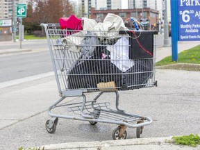 An abandoned shopping cart sits on York Street in London on April 28, 2021, near trailers set up last winter to temporarily house homeless people. The city plans to set up temporary shelters this winter at Fanshawe golf course and a second location to be named. (Derek Ruttan/The London Free Press)