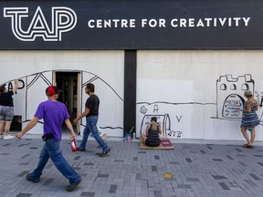 Joanne Skiba, left, Margaret Martin, centre and Heather May, paint a mural on the TAP Centre for Creativity on Dundas Street. (Mike Hensen/The London Free Press file photo)