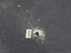 A bullet hole is visible in the second-floor window of a home on Walker Street in London after shots were fired at it. Photo taken March 2, 2021. (Mike Hensen/The London Free Press)