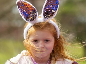 Scarlet Baratta, 5, knows she's the centre of attention with her "Easter ears" as she plays at the Springbank Park playground in London. Mike Hensen/The London Free Press