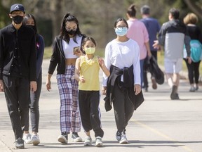 Nathan Son, 14, Veronika Son, 13, Sopharikun Sang, 15, Marinyn Sang, 8, and Chankanha Sang, 12, walk through Springbank Park on a brilliant Easter Sunday afternoon in London. The cousins were enjoying the sunny warm weather. Photograph taken on Sunday April 4, 2021. (Mike Hensen/The London Free Press)