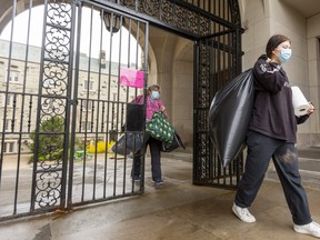 Michaela Hopley, 18, and her mom Rosanna Gaudio leave Western University's Medway Hall as they move Michaela out on Monday and head home to Newmarket. London’s three New Democrat MPPs urged the province Monday to declare the N6A postal code 
 area a provincial COVID-19 hot spot. (Mike Hensen/The London Free Press)