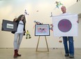 Unity Project's Sylvia Langer, left, and Museum London director Brian Meehan hold pieces for their annual UPwithArt fundraiser in London. About $142,000 has been raised and 62 of 65 works of art sold. Donations are being accepted until midnight Friday. (Mike Hensen/The London Free Press)