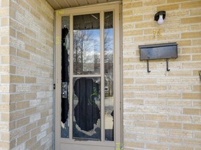 Four bullets are marked off in the front door of a unit of a townhouse complex at 2000 Wavell St. in London's east end. Starting at the bottom right, four bullets trace a diagonal to the upper left on the door and door frame.  
The bullets shattered the glass of the screen door and left holes in the metal main door.
Photograph taken on Sunday April 18, 2021. (Mike Hensen/The London Free Press)