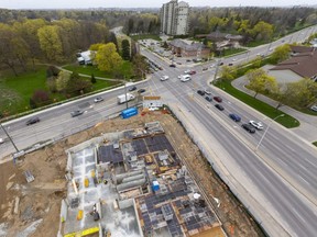 Crews from EllisDon are working on a new tower being built by York Developments at the southwest corner of Springbank Drive and Wonderland Road in London. Photo taken Tuesday April 20, 2021. (Mike Hensen/The London Free Press)