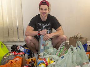 Michael Boushy, who played with the London Nationals before joining the varsity hockey team at Western University, is collecting donations of food from Western students preparing to move home as the school year ends. Boushy and his friends have collected about $1,200 worth of food in what he calls the "cabinet clean-out." (Mike Hensen/The London Free Press)