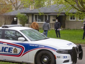 Gary Mosburger of the London fire department, second from right, talks to two London police officers in front of a home on Trott Drive in west London following a suspicious fire early Thursday that caused an estimated $500,000 in damage. The fire is the sixth suspicious blaze in London since April 8. Photograph taken Thursday April 29, 2021. (Mike Hensen/The London Free Press)