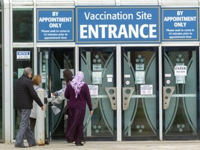People arrive for their COVID-19 vaccinations at the Western Fair Agriplex in London on April 25, 2021.