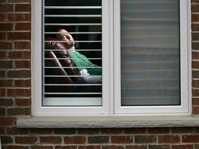 Mario Vella looks out to his backyard in this file photo. He has died after a lengthy battle with ALS. (Derek Ruttan/The London Free Press)