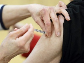 Needle into arm at the COVID-19 vaccination super site at RBC Convention Centre in downtown Winnipeg on Monday, March 1, 2021.