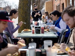 People crowd outdoor seating at a restaurant as coronavirus disease (COVID-19) restrictions are eased in Ann Arbor, Michigan, U.S., April 4, 2021.