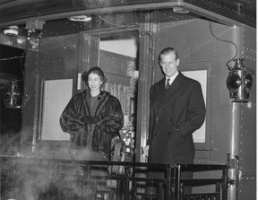 Princess Elizabeth and Prince Philip stand on the rear platform of the train in London during their royal visit in 1951. (Photo Ivey Family London Room)