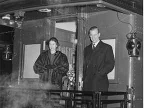 Princess Elizabeth & Prince Philip standing on rear platform of train in London, Ontario during their Royal Visit, 1951. (Ivey Family London Room photo)