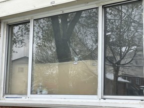 Three bullet holes are visible outside a window of a home on Cleveland Avenue struck early Wednesday in London's latest shooting. (JONATHAN JUHA/The London Free Press)