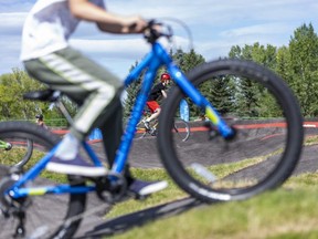 Bikers go for a ride in the South Glenmore Park's pump track on its opening day on Friday, August 14, 2020. The pump track is open to public and suitable for riders of all ages and skill levels.  (Azin Ghaffari/Postmedia Network)