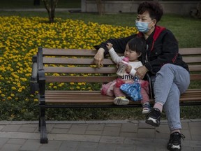 A woman sits with a child at a local park on May 12, 2021 in Beijing, China. According to data released by the government from a national census, China's population grew 0.53 percent over the last 10 years down from 0.57 percent a decade ago bringing the population to 1.41 billion. (Photo by Kevin Frayer/Getty Images)