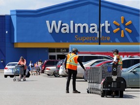 Walmart workers collect shopping carts at the South Windsor Walmart on Dougall Road in this file photo from July.