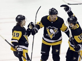 Jared McCann, left, and Jason Zucker, right, congratulate Jeff Carter of the Pittsburgh Penguins on his power play goal against the Buffalo Sabres during the first period at PPG Paints Arena on May 6, 2021. (Charles LeClaire-USA TODAY Sports)