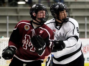 Chatham Maroons' Zach Power, left, battles Komoka Kings' Dowson Zheng in front of the Kings' net at Chatham Memorial Arena in Chatham, Ont., on Feb. 6, 2020. (Mark Malone/Chatham Daily News)