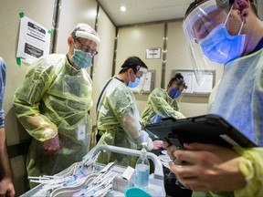 Nurses and doctors from Humber River Hospital prepare to administer the Moderna vaccine at a Toronto Community Housing seniors building in northwest Toronto.