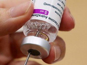 A medical worker prepares a dose of Oxford/AstraZeneca's COVID-19 vaccine at a vaccination centre in Antwerp, Belgium March 18, 2021. (REUTERS/Yves Herman/File Photo)