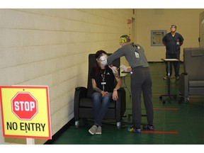 The nursing team at Windsor Regional Hospital provides vaccinations to people at St. Clair College Sportsplex in December.