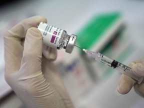 A healthcare worker fills a syringe with a dose of the AstraZeneca COVID-19 vaccine during a vaccination drive in Jakarta, Indonesia, on Tuesday, May 25, 2021.