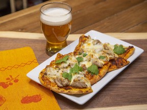 Naan flatbread makes a terrific crust for an  Indian-style pizza topped with a tikka masala-tinged tomato sauce, shredded chicken, mozzarella and cilantro, Jill Wilcox says. (Derek Ruttan/The London Free Press)