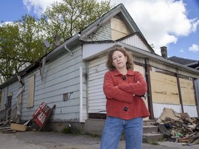 Jacqueline Thompson, executive director of LifeSpin, stands outside a house at 150 Adelaide St. N. where a suspicious fire Sunday caused about $100,000 in damage. LifeSpin warned city hall twice in five months about unsafe conditions inside the house, but no action was taken, Thompson said. Photo shot in London on Tuesday May 11, 2021. (Derek Ruttan/The London Free Press)