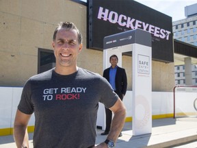 Brad Jones, president of Jones Entertainment, foreground, announced Monday it will be using the Safe Entry System at its upcoming HockeyFest road hockey event. The walk-through scanner detects symptoms of COVID-19.  Rahul Kushwah, background, is chief operating office, of Predictmedix, which developed the device. (Derek Ruttan/The London Free Press)
