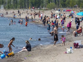 People enjoy the beach in Port Stanley Thursday. Middlesex-London Health Unit issued a heat warning Friday with an expected high of 31 C. Saturday's forecast high is 29 C, according to Environment Canada. (Derek Ruttan/The London Free Press)