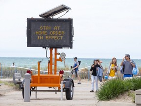 Despite a provincial stay-at-home order hundreds of people enjoyed the beach in Grand Bend on Sunday. (Derek Ruttan/The London Free Press)