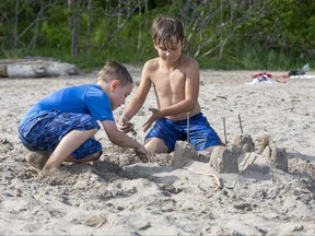 James Garry, 6, of London (left) and Luka Gajovic, 7 of London build sand castles at Little Beach in Port Stanley on Sunday May 23, 2021. James was with his mom Kelly Duggan. Luka was with his parents Aleksandar and Andrea. Derek Ruttan/The London Free Press