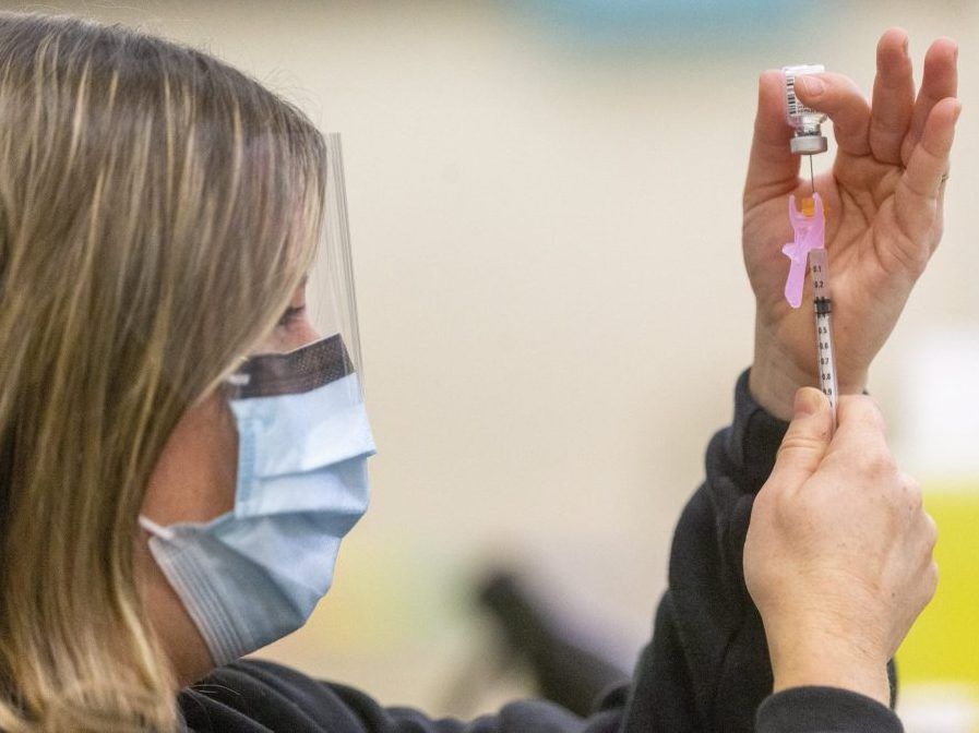 A public health nurse loads a syringe with the COVID-19 vaccine in this photo from May 2021. (Mike Hensen, The London Free Press)