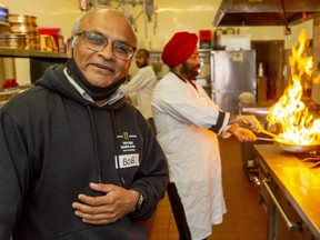 Bob Patel, owner of Wayside Restaurant in Talbotville, and other volunteers will begin giving out free meals once a week in St. Thomas to help people struggling during the pandemic. Chef Swarn Deep Singh sears peppers on the stove in the background. (Mike Hensen/The London Free Press)