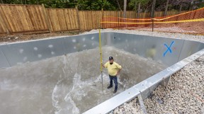 Guy Durston of Warehouse Guys stands inside a new pool going in at a home in the Orchard Park neighbourhood in London. Warehouse Guys and other pool installers say they can't keep up with demand from homeowners who want to put in pools because they're stuck at home during the COVID-19 pandemic. Photograph taken on Friday May 7, 2021. (Mike Hensen/The London Free Press)