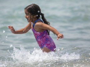 Aleena Sobh, 5, plays in the small waves in Lake Erie on the main beach in Port Stanley on Tuesday May 25, 2021. (Mike Hensen/The London Free Press)