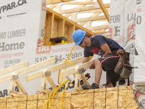 Jacob Griffin of Goldeye Construction works on a new home being built south of Wharncliffe Road between Southdale and Wonderland roads in London on Tuesday. Local housing starts saw a 66 per cent increase in the first four months of 2021 over the previous year. (Mike Hensen/The London Free Press)