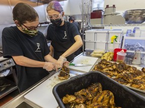 Students Mason Ritchie, left, and Caity Laidlaw have found work for the summer in the kitchen at Youth Opportunities Unlimited, the London social services agency for young people. (Mike Hensen/The London Free Press)