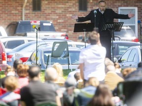 Rev. Henry Hildebrandt preaches to a crowd police estimate at nearly 300 outside the Church of God in Aylmer on Sunday. Aylmer police say more charges are pending over the latest outdoor gathering, which breaches Ontario COVID-19 laws. Photo taken Sunday May 30, 2021. Mike Hensen/The London Free Press